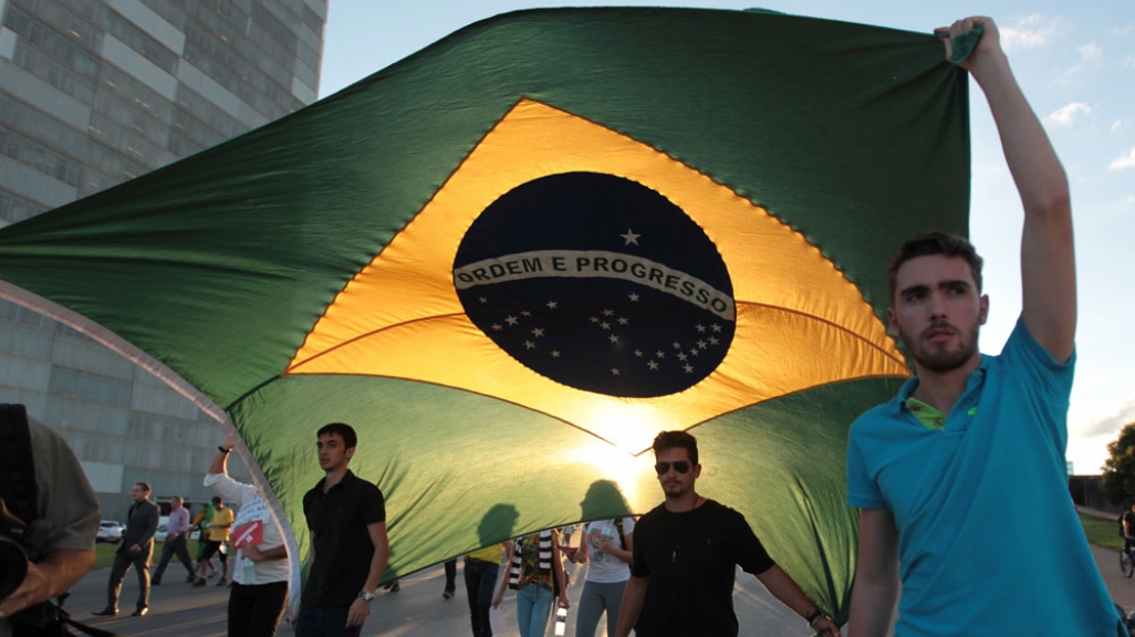 Anti-government protestors parade Brazilian flag