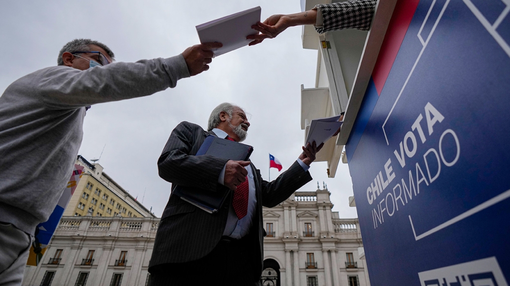 Chileans receive copies of the new draft Constitution. (AP)