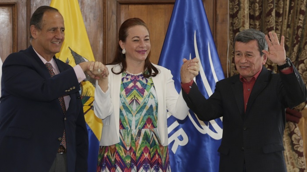Ecuador's Foreign Minister Fernanda Espinosa stands between ELN rebel leader Pablo Beltran, right, and Colombia's government representative Juan Camilo Restrepo at the end of a press conference announcing the signing of a cease-fire in Quito, Ecuador