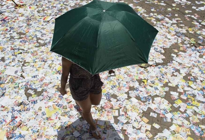 A voter steps on election flyers in Brazil 2017