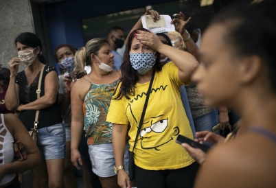 Women in Rio de Janeiro wait outside a government-run bank having technical problems to distribute their aid money. (AP)