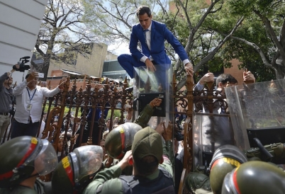 Juan Guaidó tries to scale fence of the National Assembly. (AP)