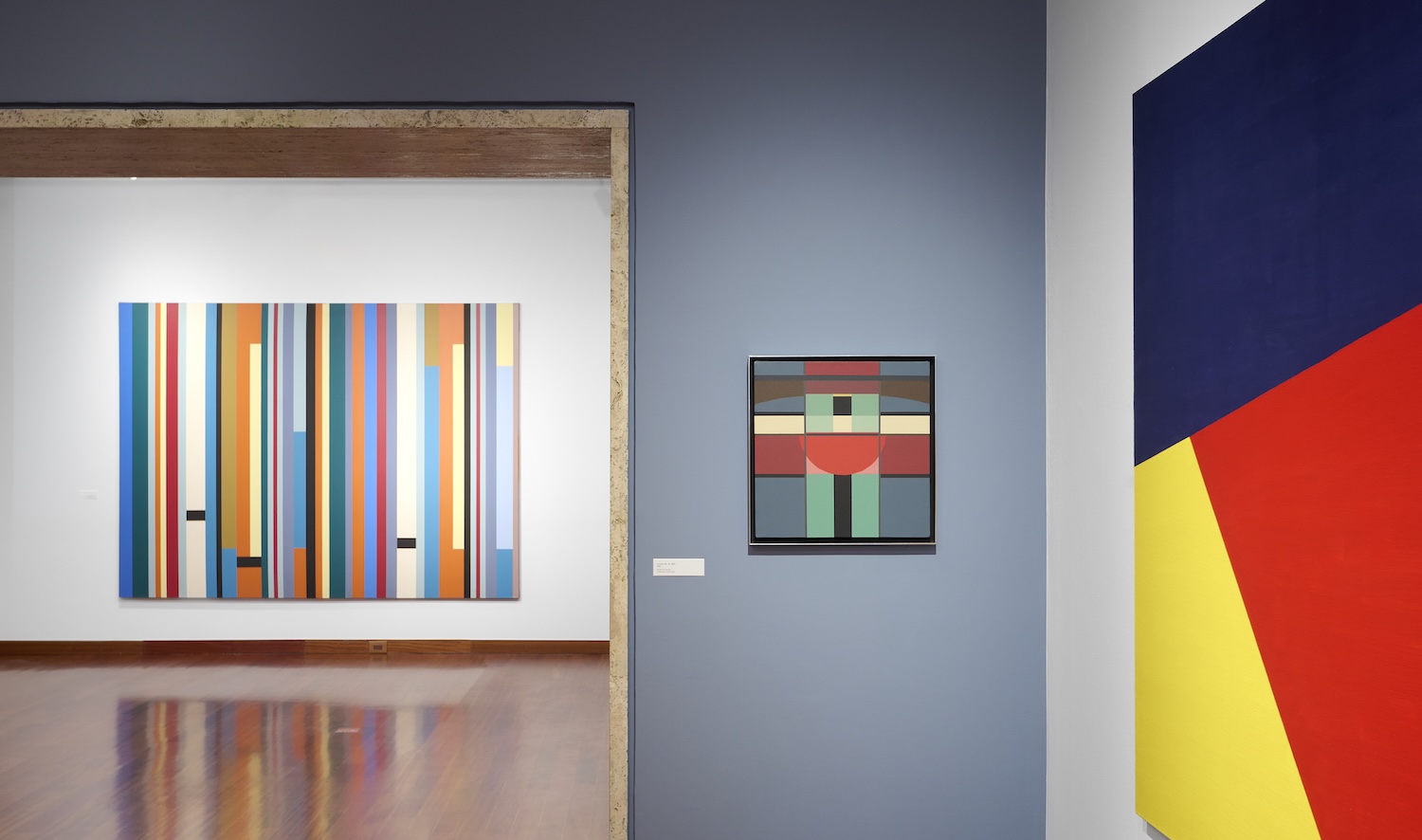 Installation view of an exhibition space showing three geometric pieces of art.