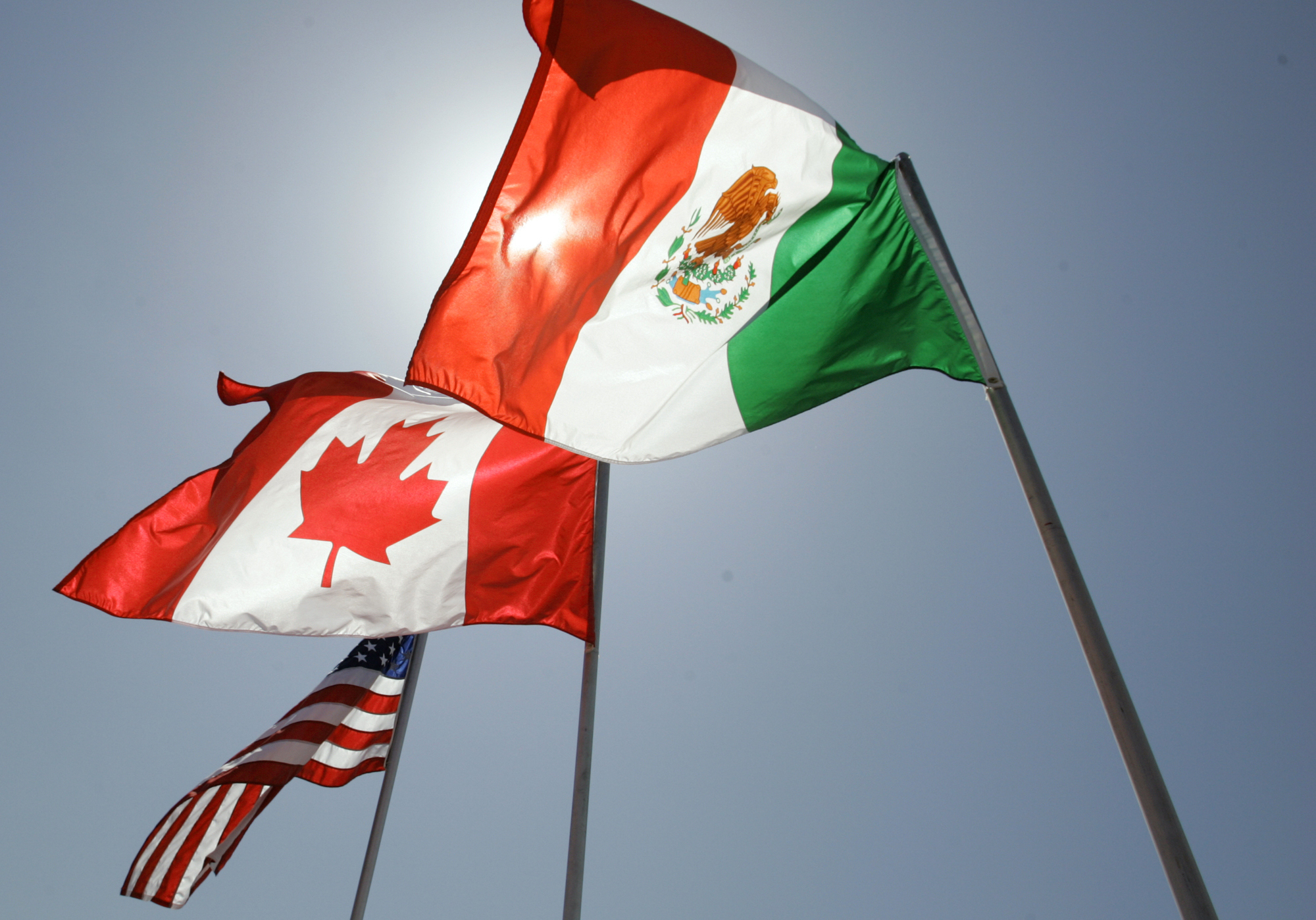 The flags of the United States, Canada, and Mexico.