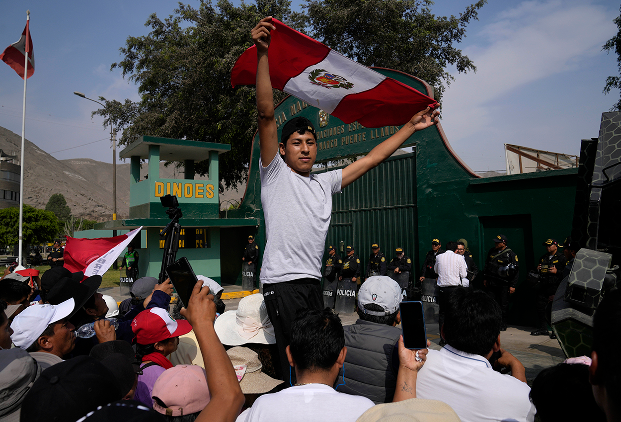 Ex-President Castillo's supporters gather outside the police station where he is held. (AP)