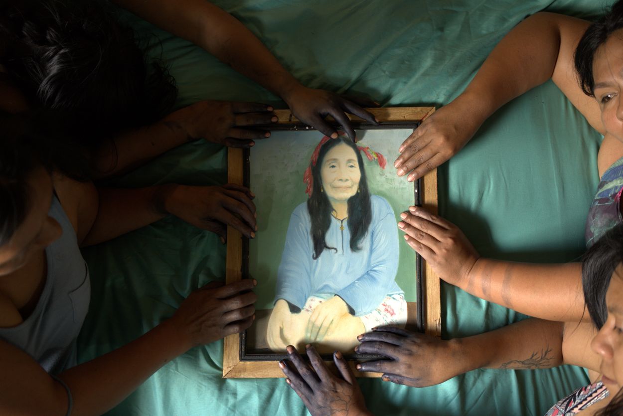 Multiple people holding a frame