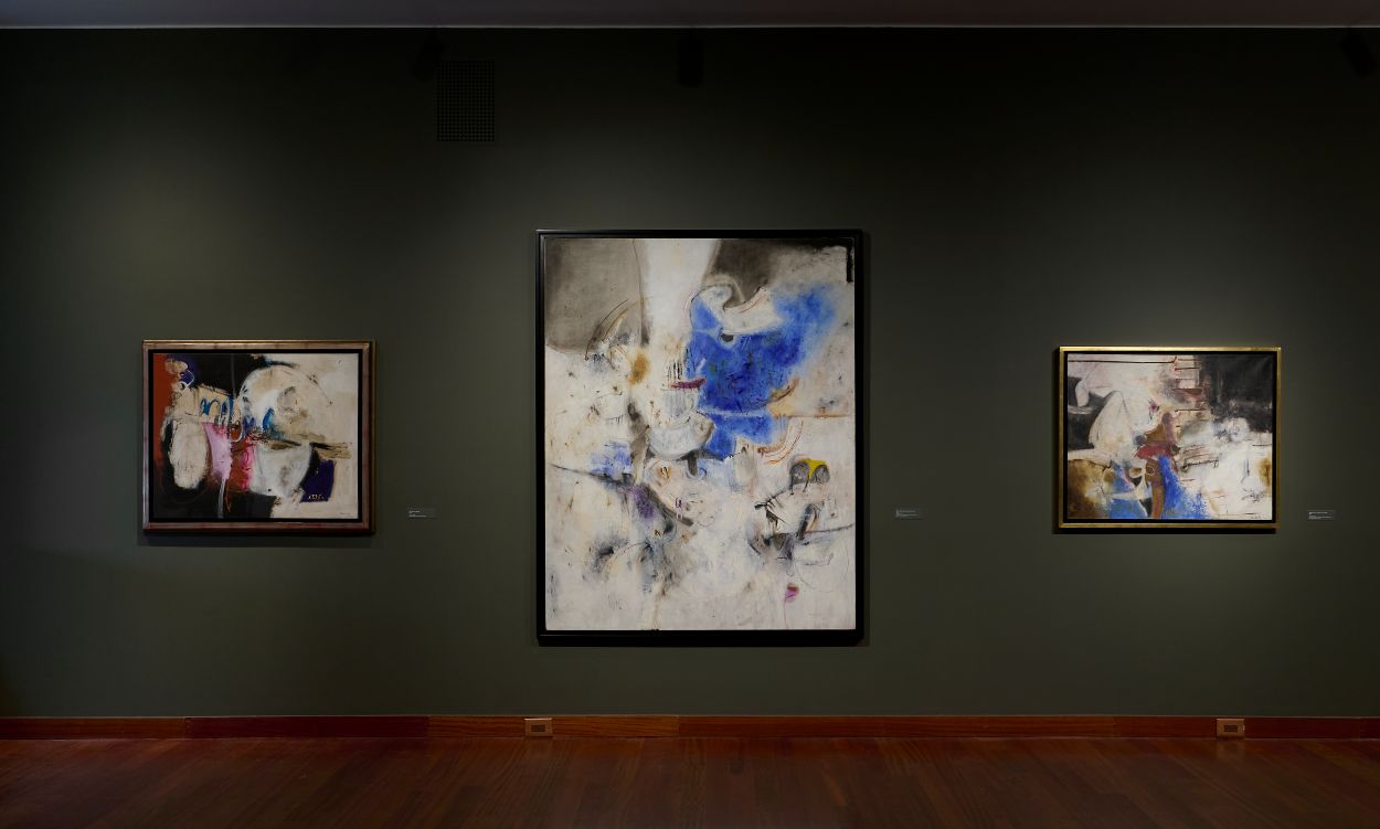Three abstract artworks on a wall