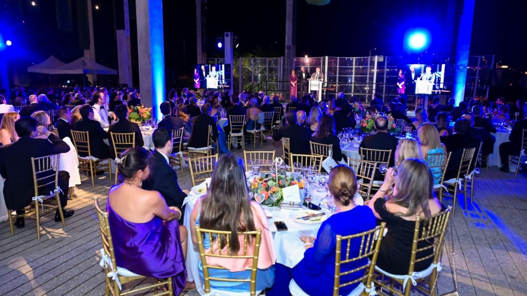 People seating around dining tables during the ceremony