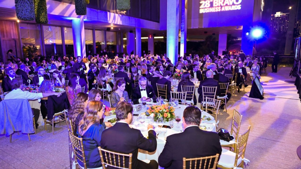 People seating around dining tables during the ceremony