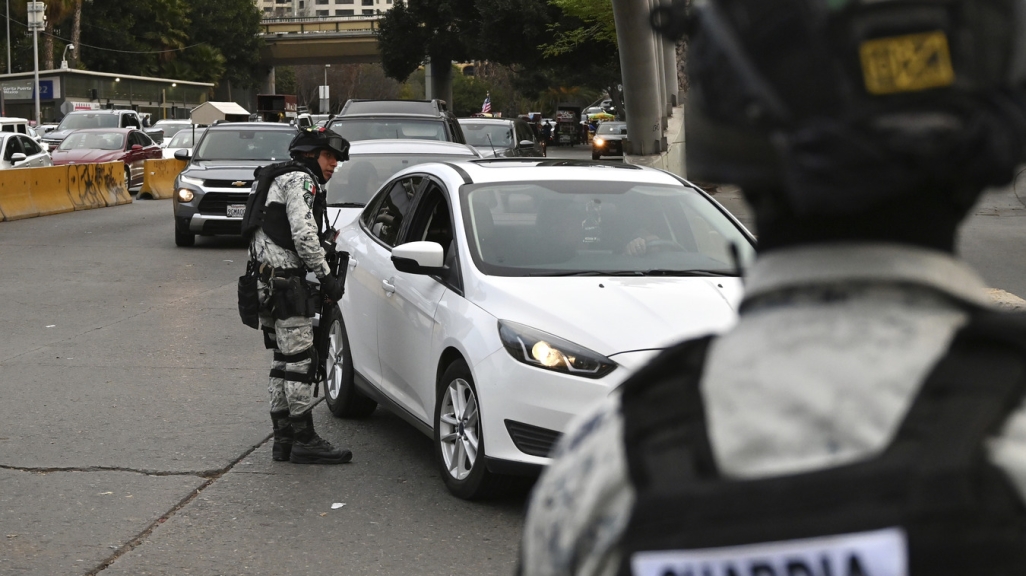 Mexican guard checking car at the border