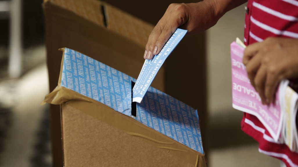 A woman casts her vote