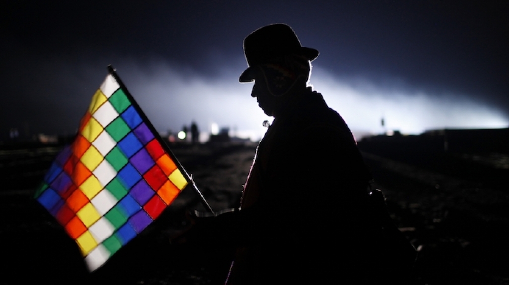 An Aymaran man holds the Wiphala flag. (AP)