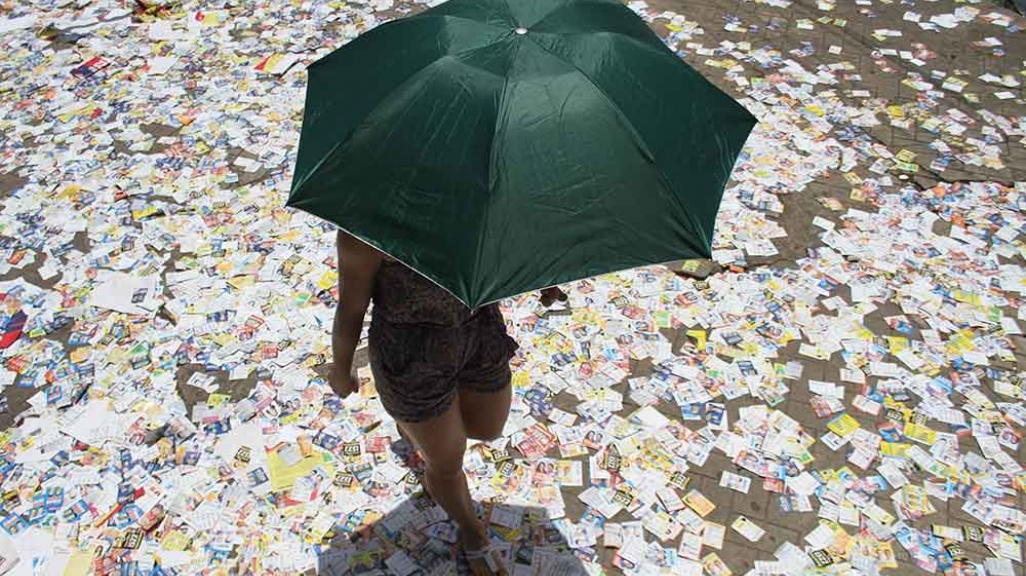 A voter steps on election flyers in Brazil 2017