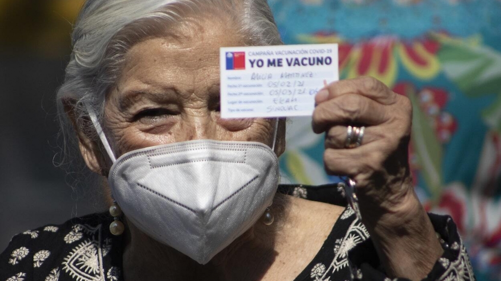 A Chilean woman shows her vaccination card. (AP)