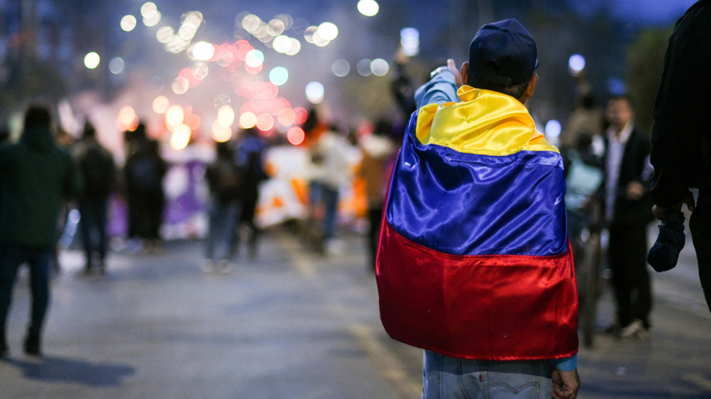 Colombian protestor wearing flag