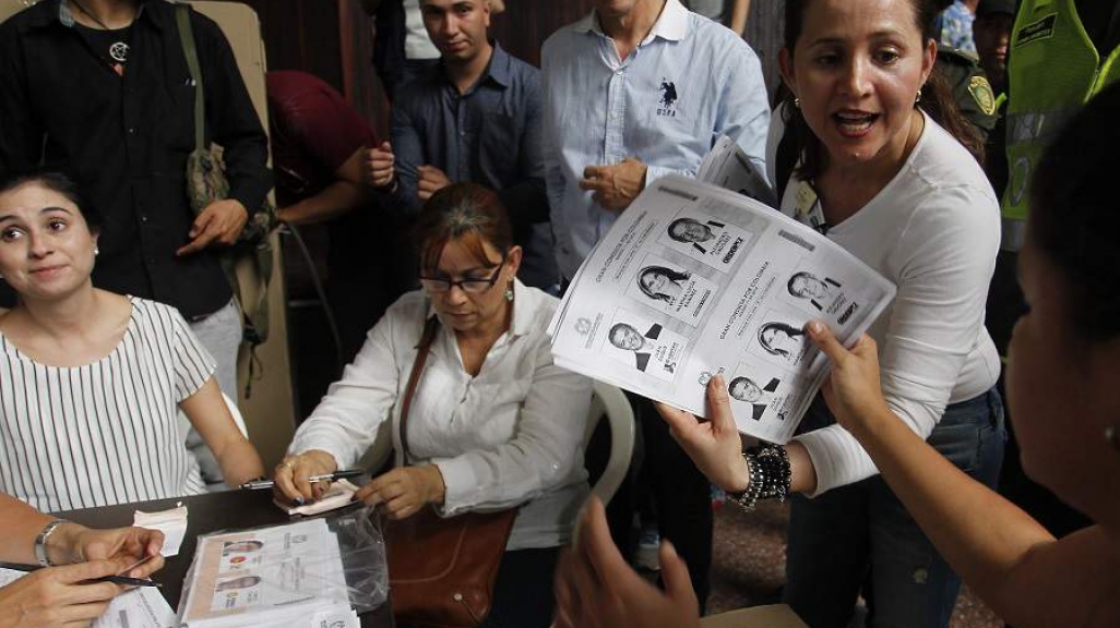 Colombian poll workers tally presidential primary ballots. (AP)