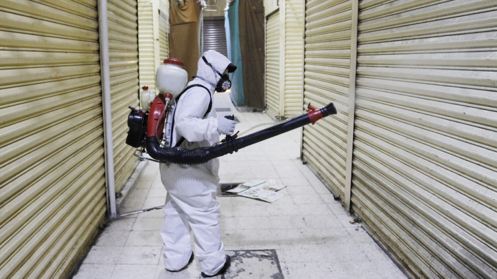 A worker disinfects a market in Mexico City. (AP)