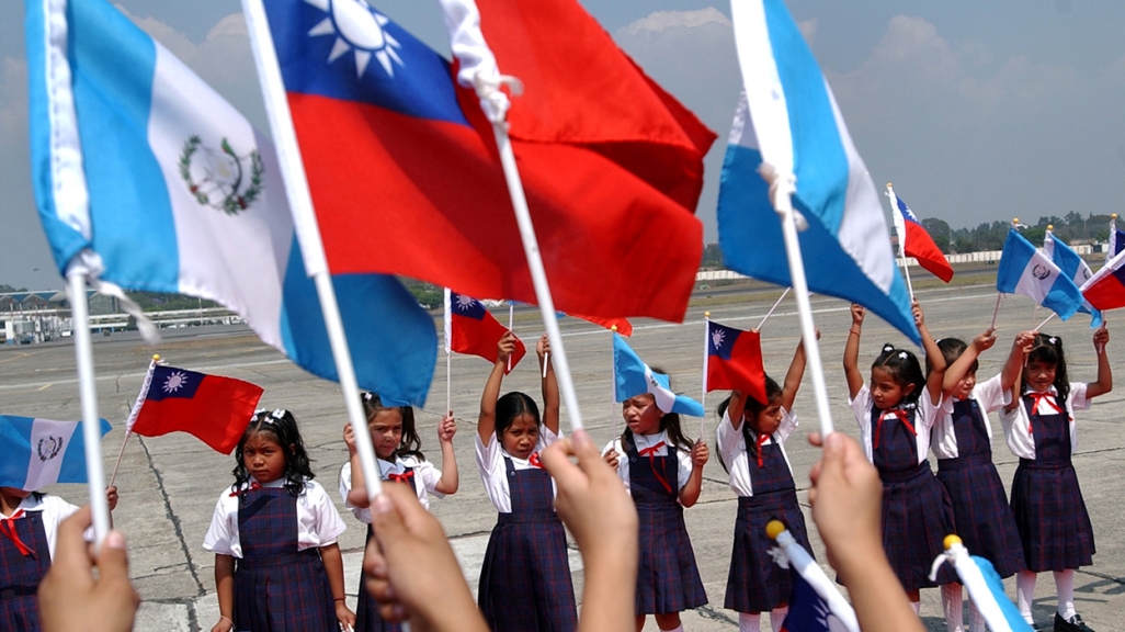 A group of children waving Guatemalan and Taiwanese flags. (AP)