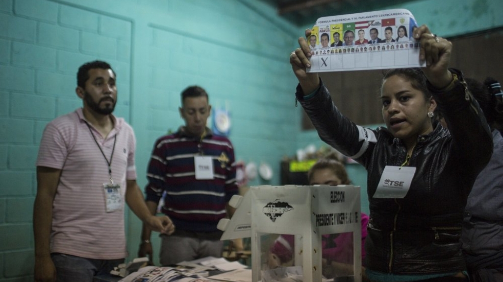 Honduran election worker holds up ballot marked for Salvador Nasralla