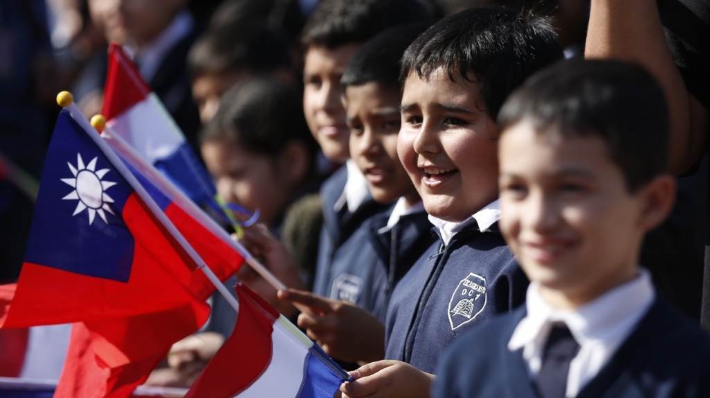 Paraguayan children wave Taiwanese flags. (AP)