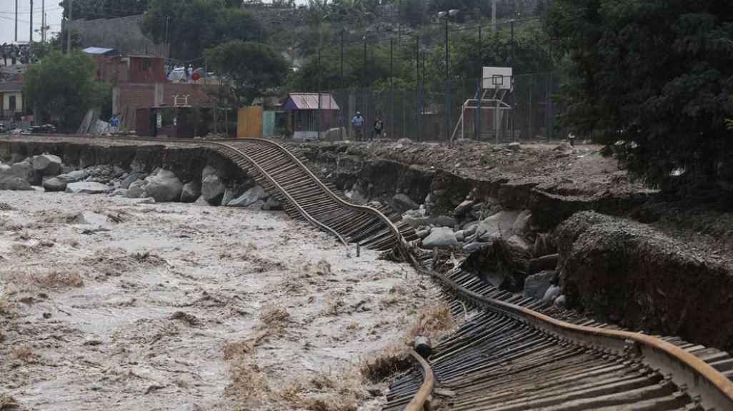 Train tracks lay destroyed in a flooded river in the Chosica district of Lima