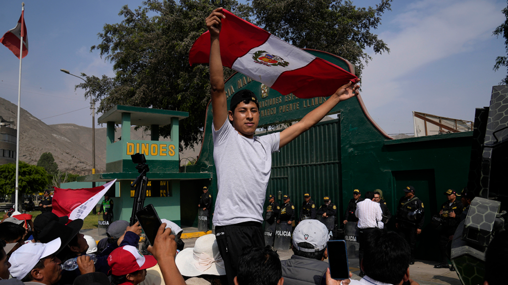 Ex-President Castillo's supporters gather outside the police station where he is held. (AP)