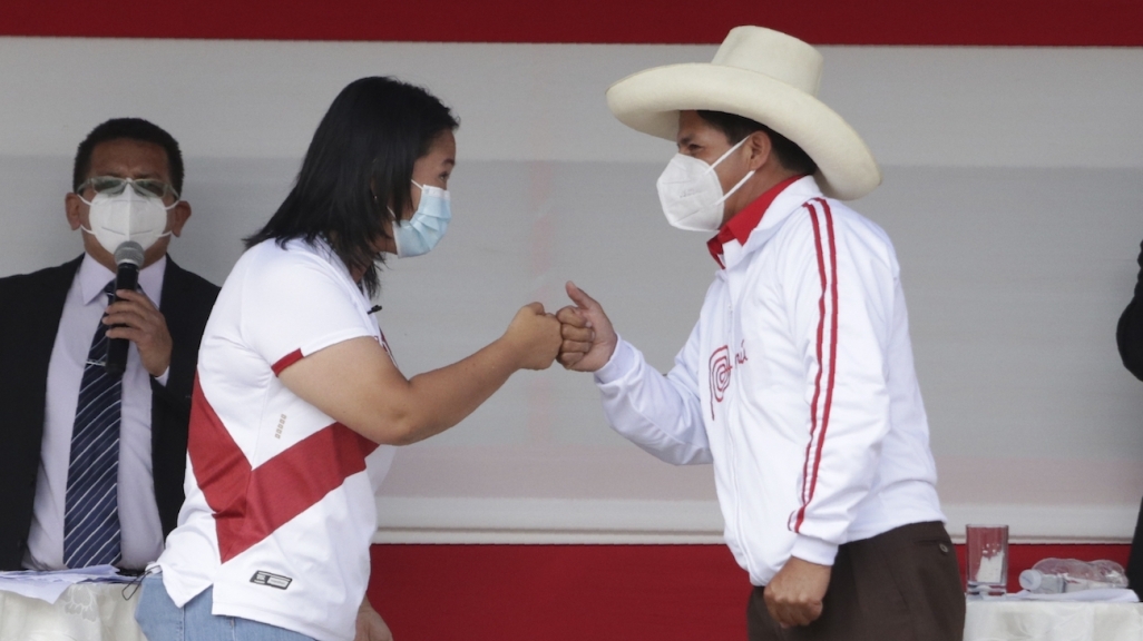 Keiko Fujimori and Pedro Castillo bump fists. (AP)