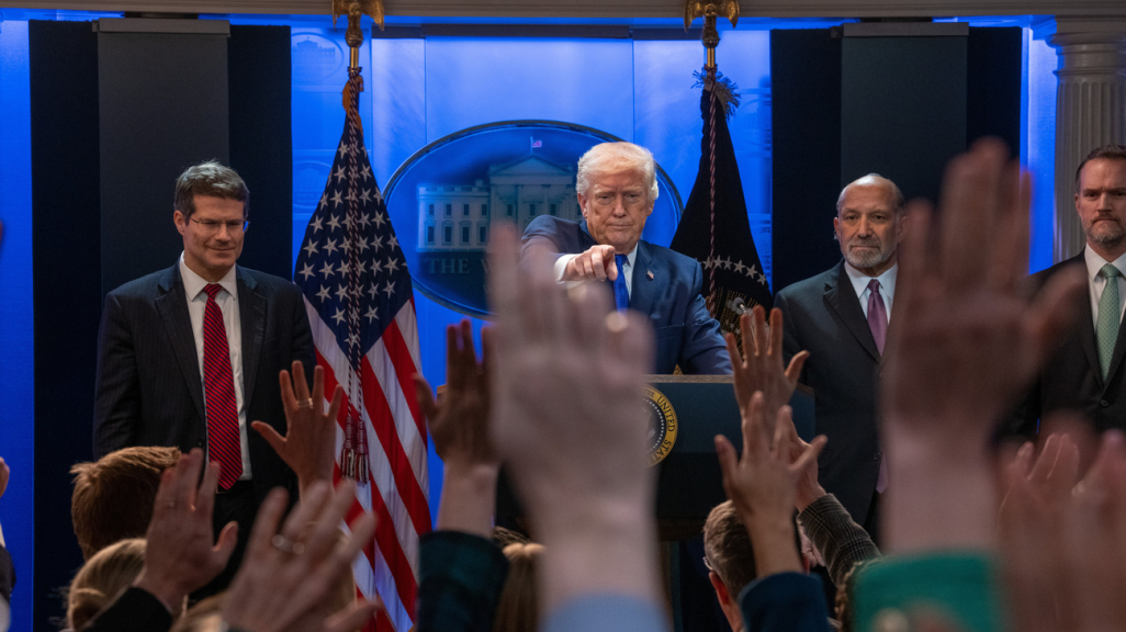 Trump pointing at a press conference.