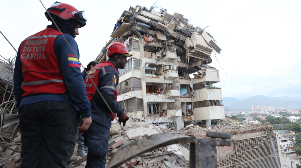 Rescue workers in Caracas. (AP)