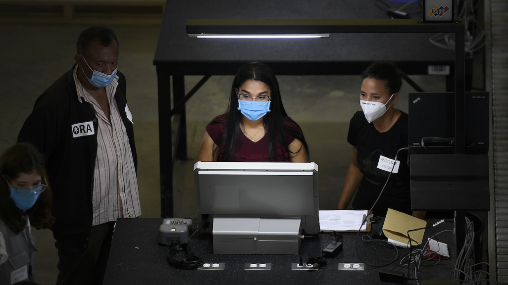 Venezuelan election workers test new voting machines. (AP)