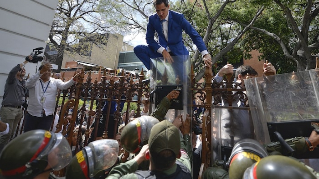 Juan Guaidó tries to scale fence of the National Assembly. (AP)