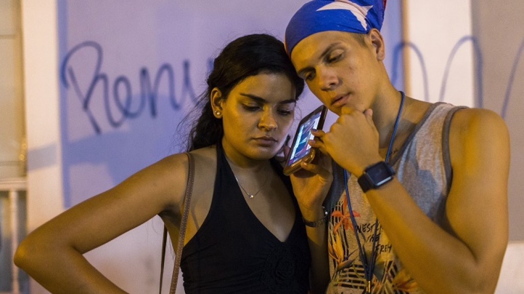 Listening to Rosselló’s resignation in San Juan. (AP)