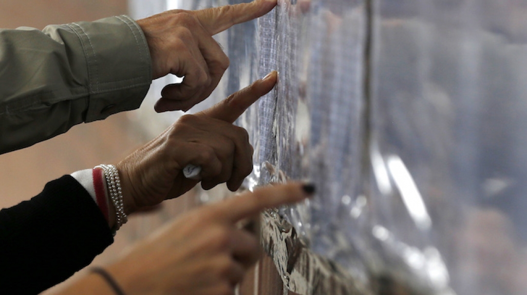 Voters check lists in Colombia.