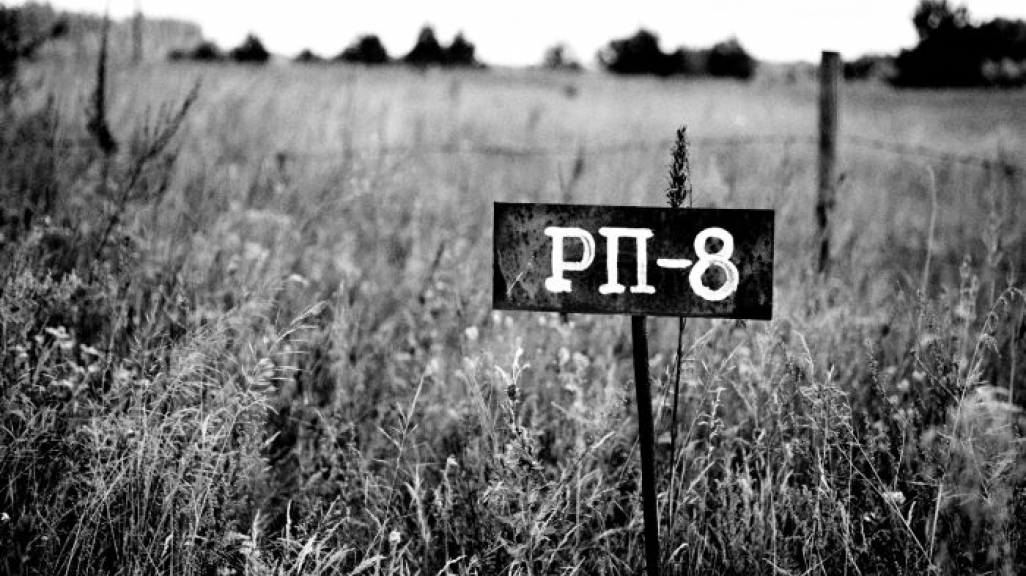 Alice Miceli, Chernobyl Exclusion Zone, PTT-8 Sign, Highly Contaminated Ground, Belarus, archival inkjet print, 2008. Courtesy of the artist and Galeria Nara Roesler.   