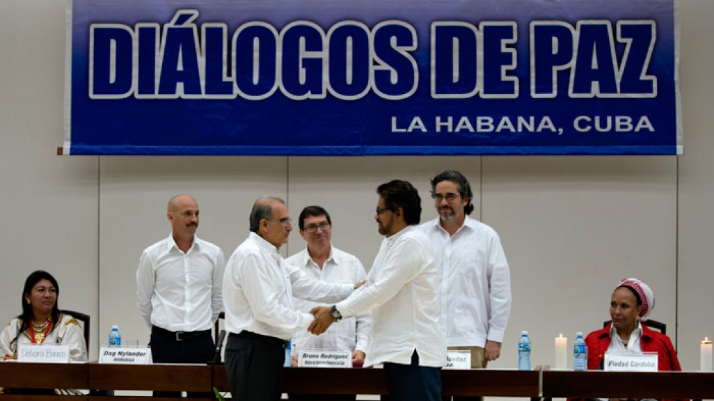 Colombian negotiators shake hands in Havana over FARC talks.