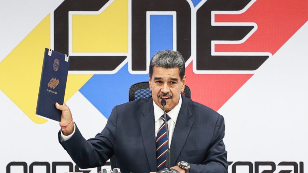 Venezuelan President Nicolás Maduro holds his certificate of election victory in Caracas on July 29.