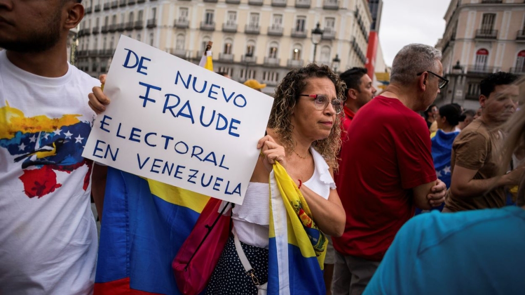Protester in Madrid holding a sign 