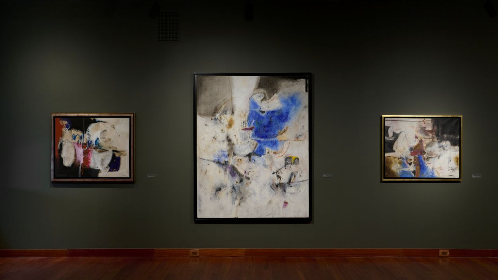 Three abstract artworks on a wall