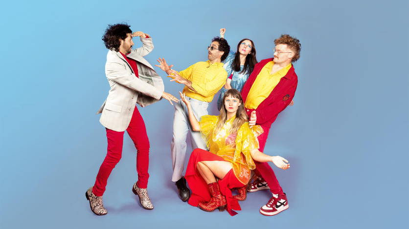 Five people in red, yellow, beige, and blue clothing pose in exaggerated comical stances against a blue background.