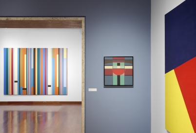 Installation view of an exhibition space showing three geometric pieces of art.