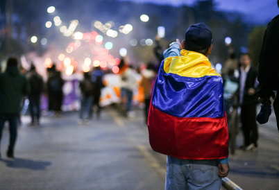 Colombian protestor wearing flag