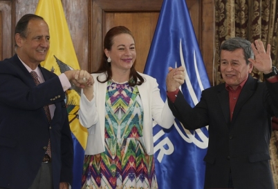 Ecuador's Foreign Minister Fernanda Espinosa stands between ELN rebel leader Pablo Beltran, right, and Colombia's government representative Juan Camilo Restrepo at the end of a press conference announcing the signing of a cease-fire in Quito, Ecuador