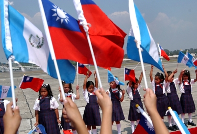A group of children waving Guatemalan and Taiwanese flags. (AP)
