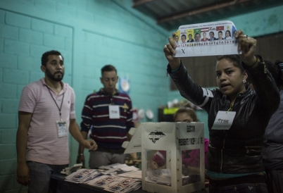 Honduran election worker holds up ballot marked for Salvador Nasralla