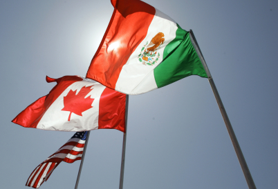 The flags of the United States, Canada, and Mexico.