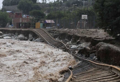 Train tracks lay destroyed in a flooded river in the Chosica district of Lima