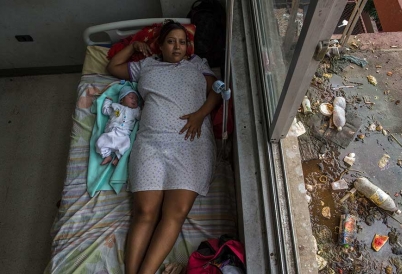 A mom and her 1-day-old baby in a Venezuelan maternity ward