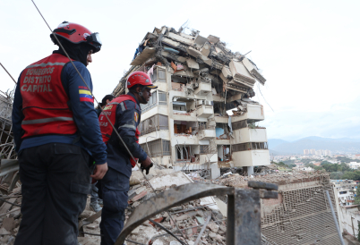 Rescue workers in Caracas. (AP)