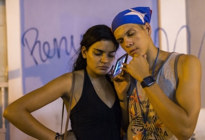 Listening to Rosselló’s resignation in San Juan. (AP)