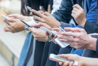 People holding cell phones (AdobeStock)